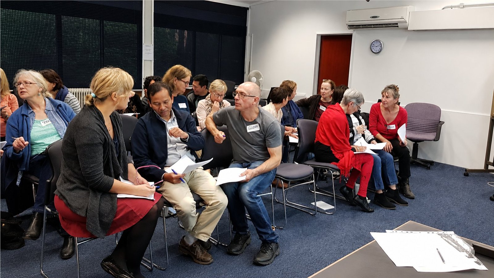 Workshop participants discussing learning material in small groups